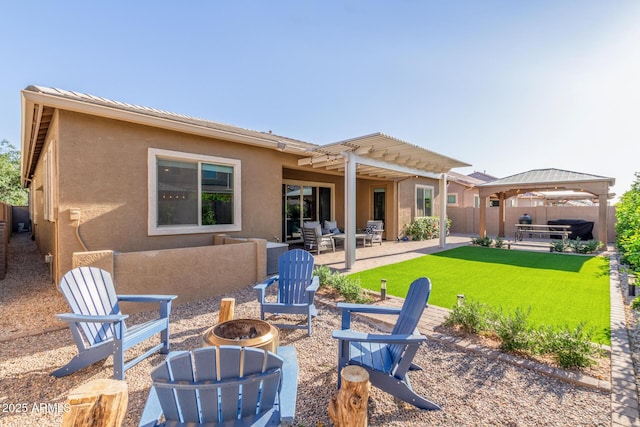 9764 E Thornbush Ave, Mesa, AZ 85212 - back of property featuring stucco siding, an outdoor living space with a fire pit, a gazebo, and a patio area
