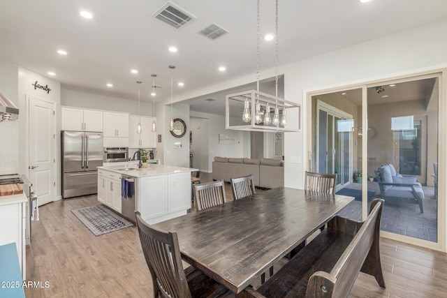 9764 E Thornbush Ave, Mesa, AZ 85212 - dining area featuring light wood-style floors and recessed lighting