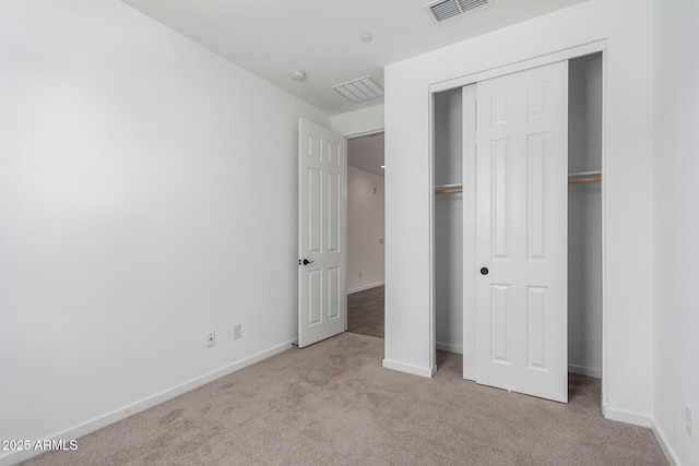 11627 W Green Dr, Youngtown, AZ 85363 - unfurnished bedroom featuring carpet floors, a closet, and baseboards