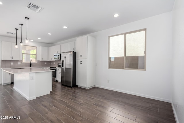11627 W Green Dr, Youngtown, AZ 85363 - kitchen featuring stainless steel appliances, a sink, light countertops, baseboards, and recessed lighting