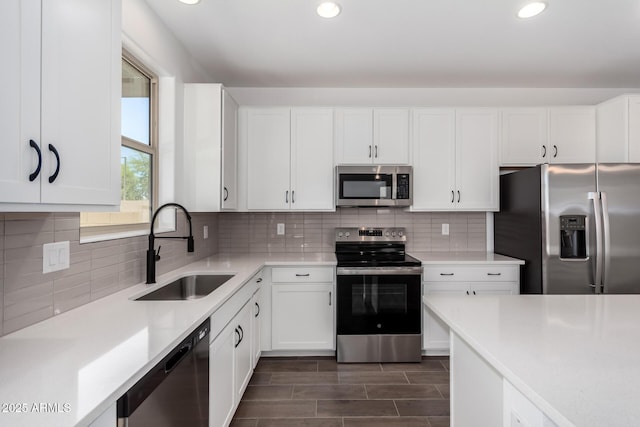 11627 W Green Dr, Youngtown, AZ 85363 - kitchen with stainless steel appliances, a sink, light countertops, recessed lighting, and white cabinets