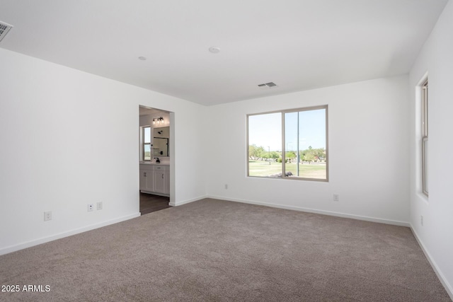 11627 W Green Dr, Youngtown, AZ 85363 - carpeted empty room featuring baseboards