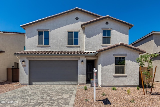 11627 W Green Dr, Youngtown, AZ 85363 - view of front of home with a tiled roof, a garage, and stucco siding