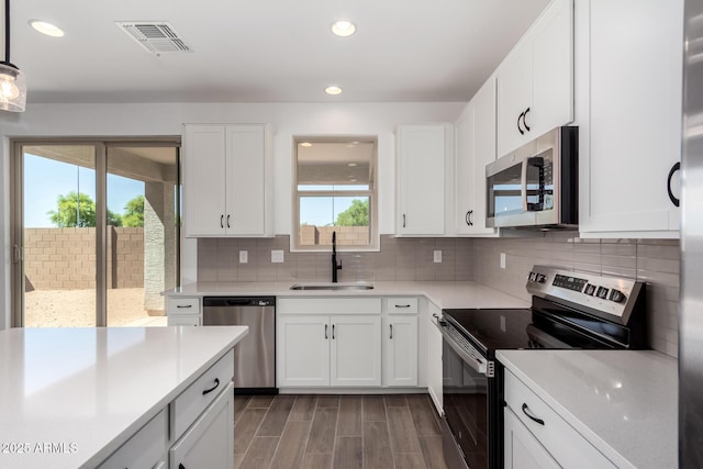 11627 W Green Dr, Youngtown, AZ 85363 - kitchen featuring appliances with stainless steel finishes, a sink, light countertops, recessed lighting, and decorative backsplash