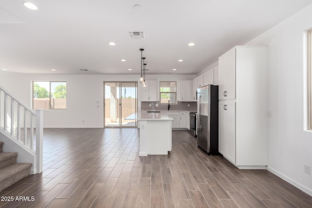 11627 W Green Dr, Youngtown, AZ 85363 - kitchen featuring stainless steel appliances, open floor plan, plenty of natural light, light countertops, and recessed lighting