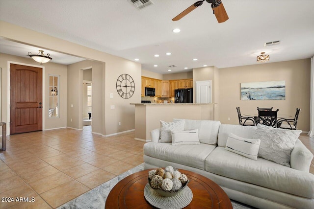 tiled living room with ceiling fan