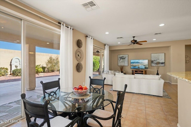 dining area with light tile patterned floors and ceiling fan