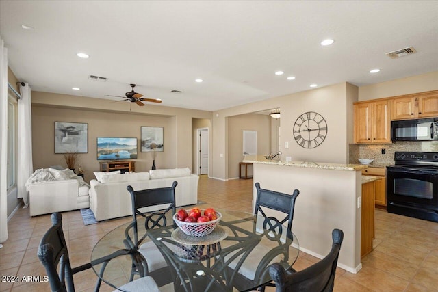 dining area with light tile patterned floors and ceiling fan