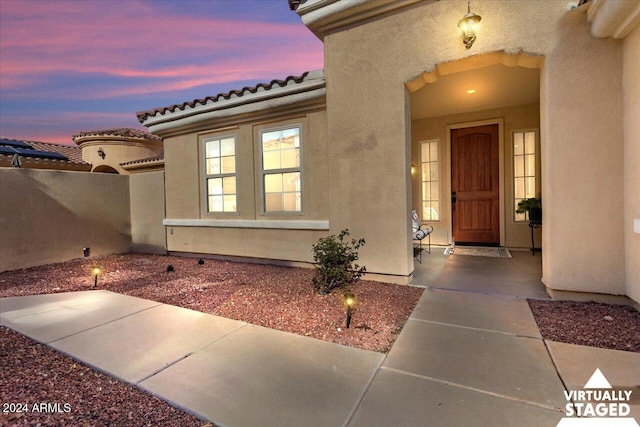 view of exterior entry at dusk