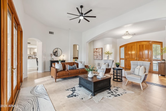 tiled living room with ceiling fan