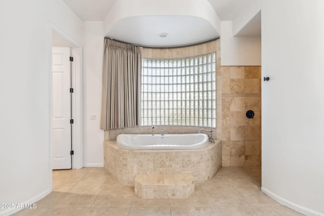 bathroom with tile patterned floors and tiled tub