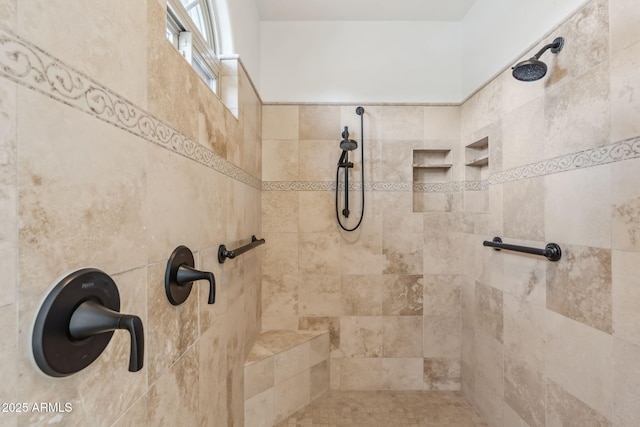 bathroom with a tile shower