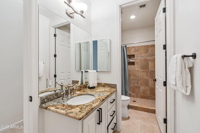 bathroom featuring vanity, curtained shower, tile patterned floors, and toilet