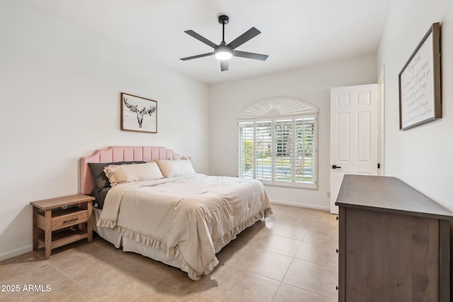 tiled bedroom featuring ceiling fan