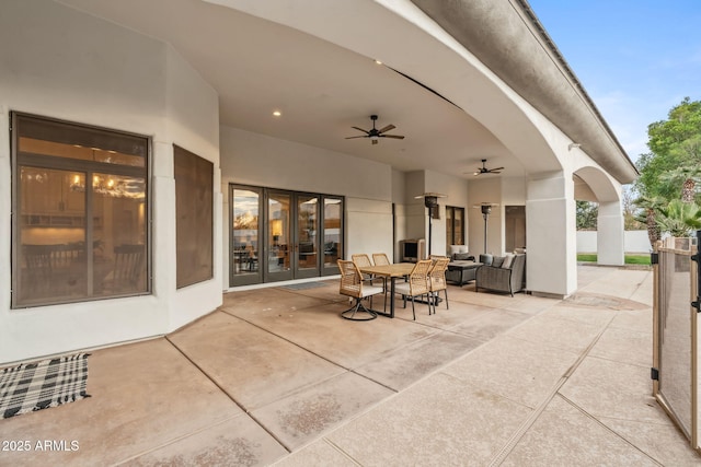 view of patio / terrace featuring an outdoor living space, french doors, and ceiling fan