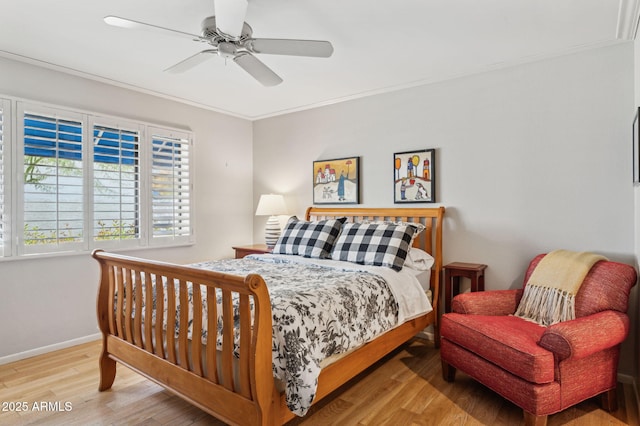 bedroom with ceiling fan, wood finished floors, baseboards, and ornamental molding