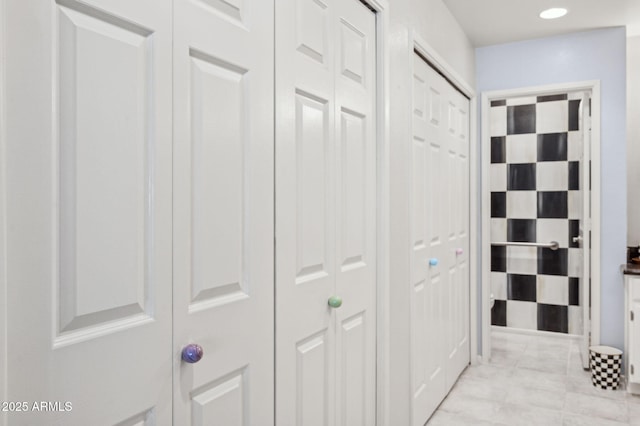 hallway with light tile patterned flooring and recessed lighting