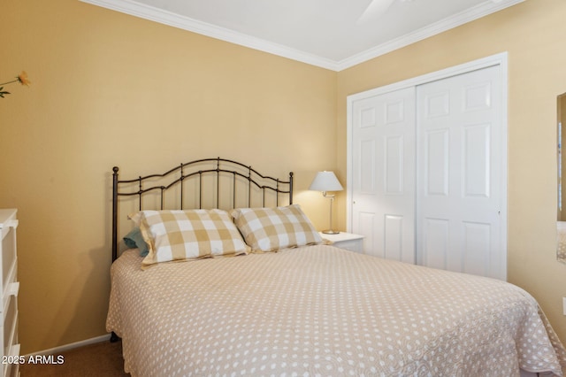 carpeted bedroom with crown molding, baseboards, and a closet