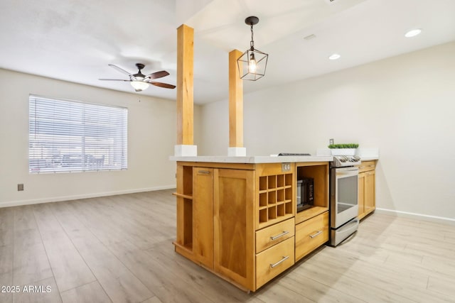 kitchen with black microwave, baseboards, stainless steel range with electric cooktop, light countertops, and light wood finished floors