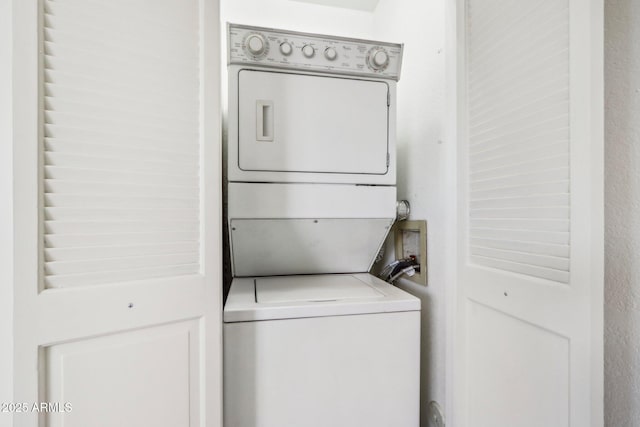 laundry area with stacked washer and clothes dryer and laundry area