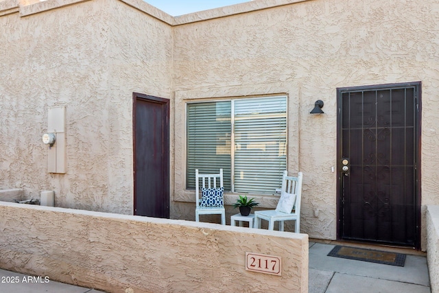 doorway to property with stucco siding