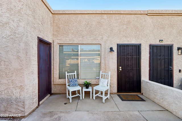 entrance to property with stucco siding