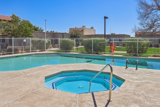 community pool featuring a community hot tub, a patio, and fence