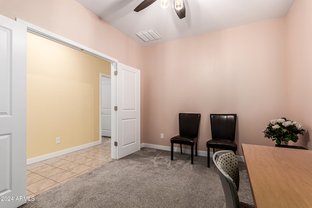 sitting room featuring light carpet and ceiling fan