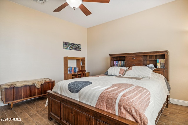 bedroom with ceiling fan and dark hardwood / wood-style flooring