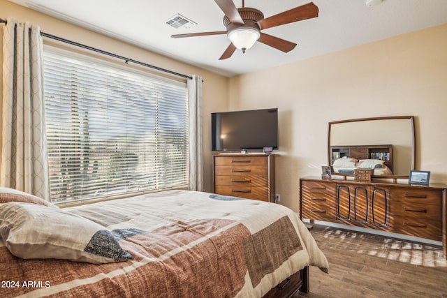 bedroom with hardwood / wood-style floors and ceiling fan