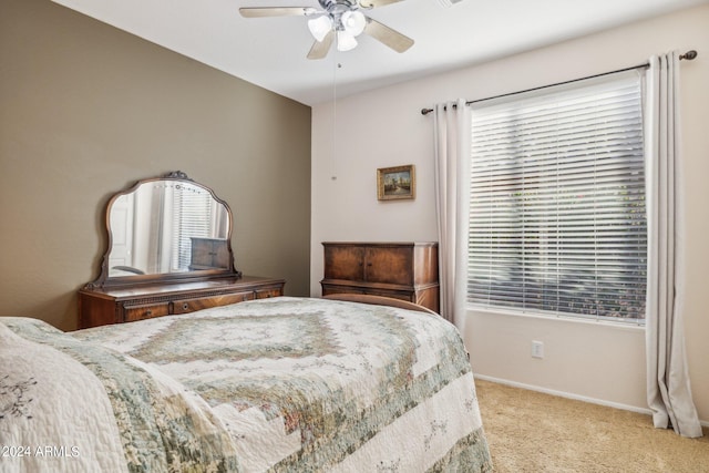 carpeted bedroom with ceiling fan and multiple windows