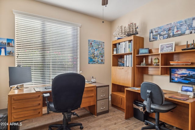 home office featuring ceiling fan, light wood-type flooring, and a wealth of natural light