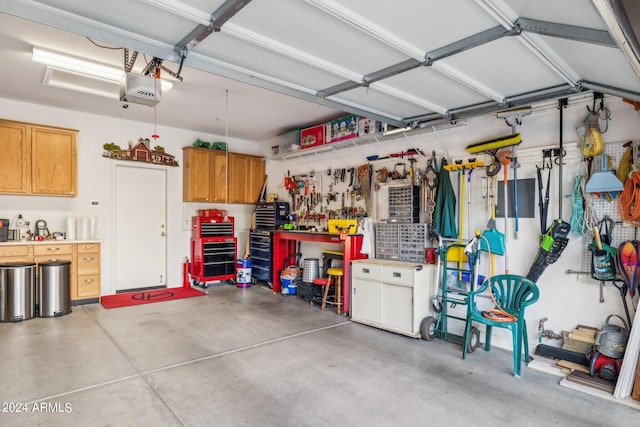 garage with a garage door opener and a workshop area