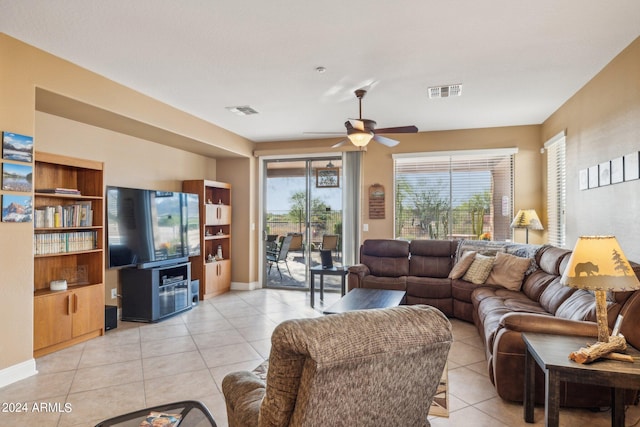 living room featuring light tile patterned floors, baseboards, visible vents, and a ceiling fan