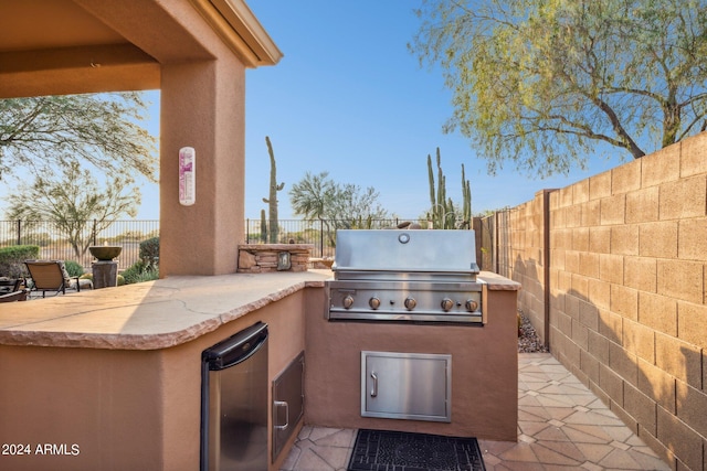 view of patio featuring a grill and exterior kitchen