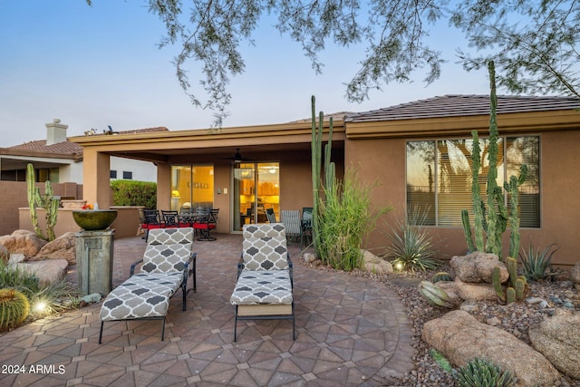 back house at dusk with a patio