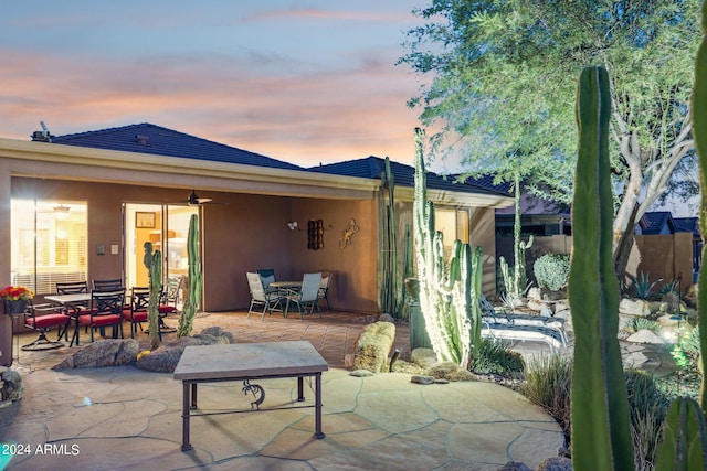 view of patio terrace at dusk