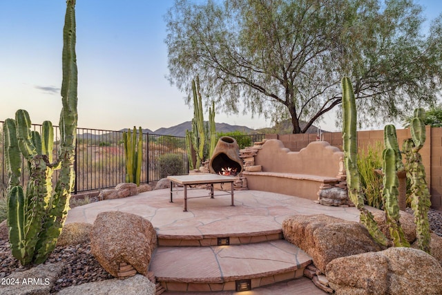 patio terrace at dusk with a mountain view