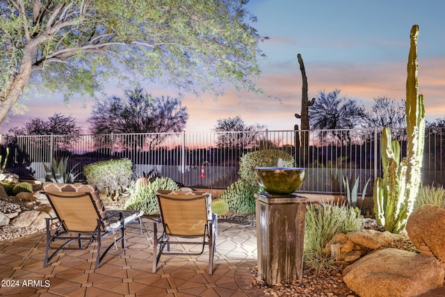 view of patio terrace at dusk