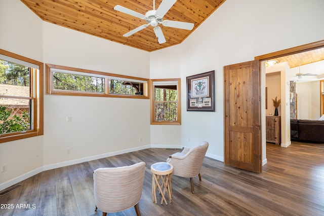 living area featuring high vaulted ceiling, wood ceiling, baseboards, and wood finished floors