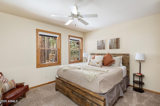 carpeted bedroom featuring a ceiling fan and baseboards