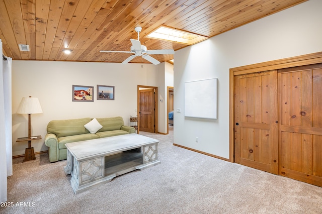 living room with lofted ceiling with skylight, carpet, wooden ceiling, and visible vents