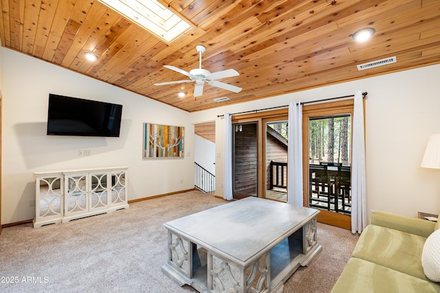 living room with vaulted ceiling with skylight, visible vents, baseboards, wood ceiling, and carpet