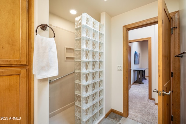 bathroom with walk in shower and baseboards