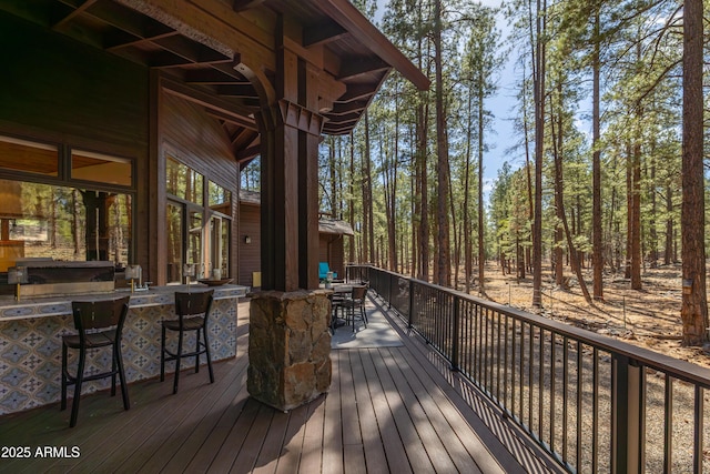 wooden deck with outdoor dry bar and outdoor dining area