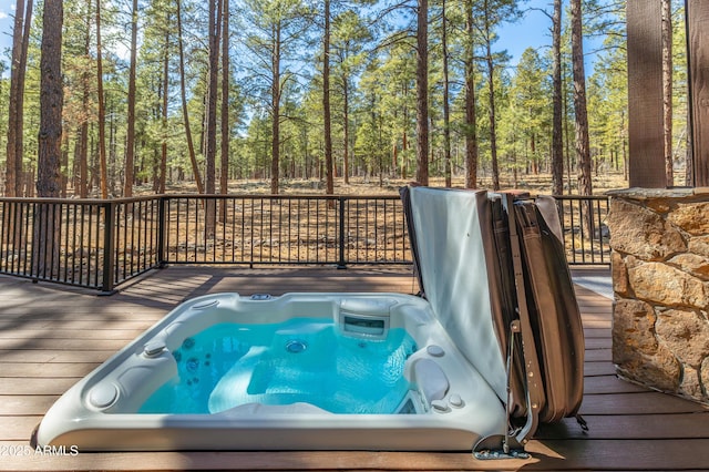 wooden deck featuring hot tub deck surround