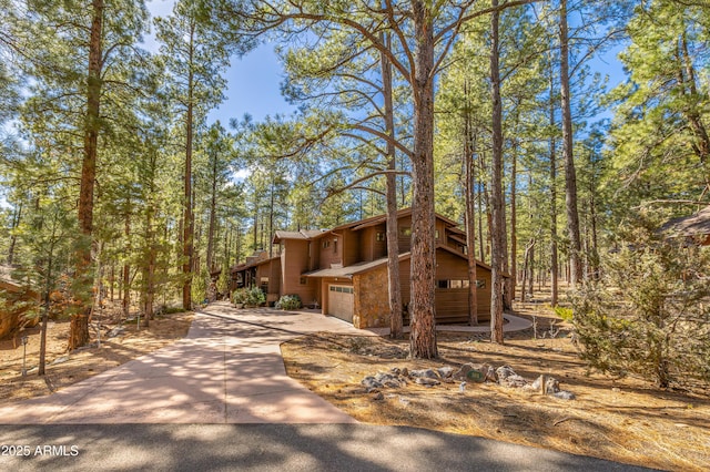 view of front of home featuring concrete driveway and an attached garage