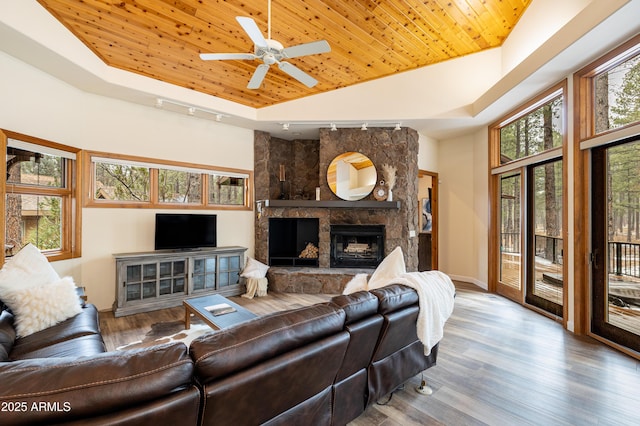 living room with wooden ceiling, a fireplace, high vaulted ceiling, and wood finished floors