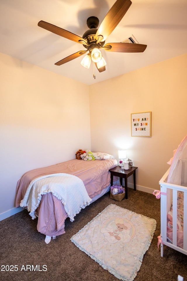 bedroom with ceiling fan and dark colored carpet