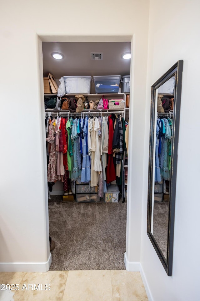 walk in closet featuring carpet floors